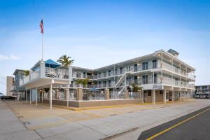 a large building with an american flag in front of it at 301 Ocean Ave, Unit 104 - The Harbor Light in North Wildwood
