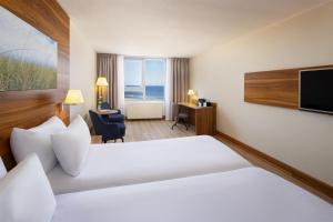 Ein Bett oder Betten in einem Zimmer der Unterkunft NH Zandvoort Hotel
