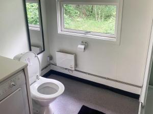 a bathroom with a white toilet and a window at 6 person holiday home in Bording-By Traum in Bording Stationsby