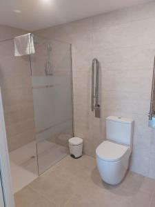 a bathroom with a toilet and a glass shower at Hotel Nuevo Ondina in Begur +62 photos
