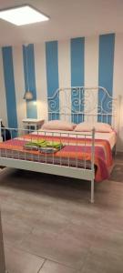 a bed in a room with a blue and white wall at B&B Da Nonna 'Nzia in SantʼEusanio del Sangro