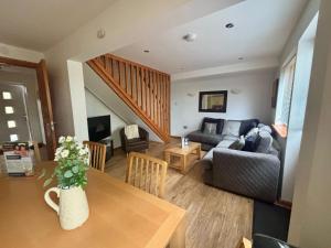 a living room with a couch and a table at Acorn Lodge in Newton Abbot