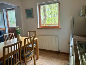 a kitchen and dining room with a table and chairs at Acorn Lodge in Newton Abbot