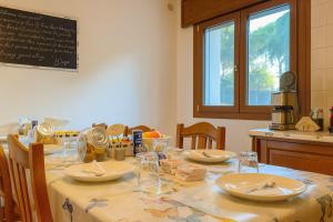 a table with plates and dishes on it in a kitchen at B&B Airport Venice Diego 2 in Tessera