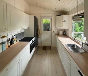 a kitchen with white cabinets and a sink at Cozy Family Holiday Home By Nordstrand in Nykøbing Sjælland