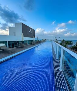 a swimming pool on the roof of a building at Flat Piscina Privativa 90 MT Praia centro in Porto De Galinhas