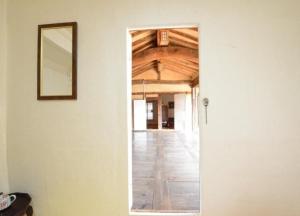 a hallway with a mirror on the wall and a hallwayngthngthngthngthngth at Chungsong Chalbang Gongjongtaek Pension in Cheongsong +13 photos