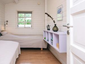 a bedroom with a bed and a window at 4 star holiday home in Hejls in Hejls