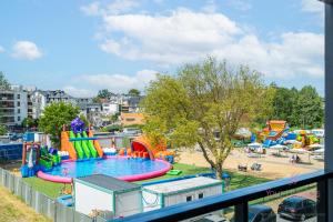 a view of a playground with a water park at Your Holidays Bel Mare Aqua E208 in Międzyzdroje