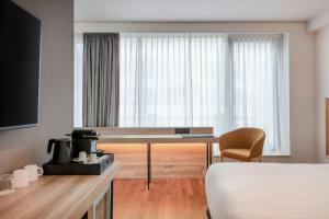 a hotel room with a desk and a bed at AC Hotel by Marriott Bratislava Old Town in Bratislava +51 photos
