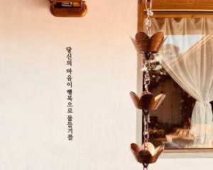 a mirror with a chandelier in front of a window at Jeonju Sosohanhanok in Jeonju +49 photos