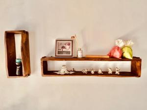 a wooden shelf on a wall with a mirror at Jeonju Sosohanhanok in Jeonju