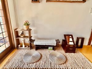 a living room with a table and a rug at Jeonju Sosohanhanok in Jeonju