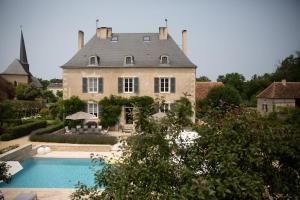 a large house with a swimming pool in front of it at Domaine la valette in Thollet