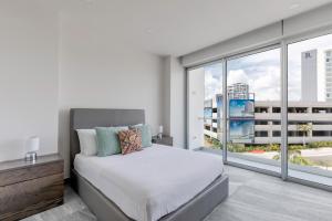 a bedroom with a bed and a large window at Luxurious 4BR condo by the beach - Rooftop pool in Cancún