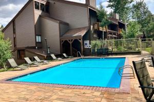 a swimming pool in front of a house at Mammoth Ski & Racquet 124 in Mammoth Lakes