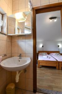 a bathroom with a sink and a bedroom with a bed at House Vukovic in Grabovac +102 photos