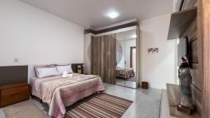 Ένα ή περισσότερα κρεβάτια σε δωμάτιο στο Refúgio Exclusivo em Arraial do Cabo