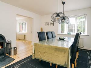 a dining room with a table and chairs and a fireplace at 7 person holiday home in Asnæs in Asnæs +32 photos
