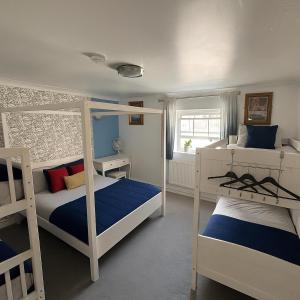 a bedroom with two bunk beds and a window at The Brighton Parlour with Hot Tub in Brighton & Hove