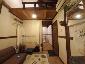 a living room with a couch and a window at Jeonju Sanyacho Pension in Jeonju