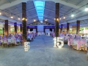 a banquet hall with purple tables and chairs and a number six at Casona Resort Villa Conchita in Carmen de Apicalá