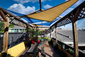 awning over a patio with benches and plants at Kkot Jari Hanok Pension in Jeonju +70 photos
