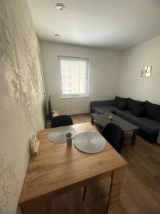 a living room with a table and a couch at Apartmán NIKA Choceň in Choceň +4 photos