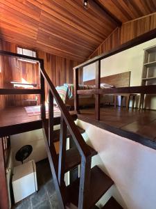 a room with a staircase and a bunk bed at Pousada Cachoeira in Abraão