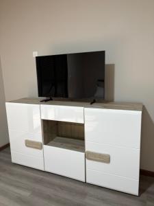 a white entertainment center with a tv on top at Studio- Rémire-Montjoly in Montjoly
