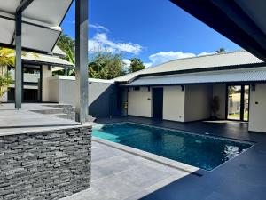 a swimming pool in the backyard of a house at Studio- Rémire-Montjoly in Montjoly