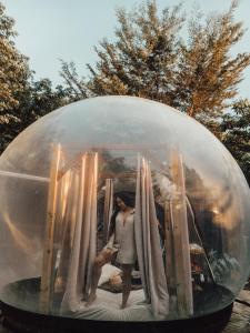 a man is standing inside of a large plastic ball at Sierra Linda Glamping in Aibonito +39 photos