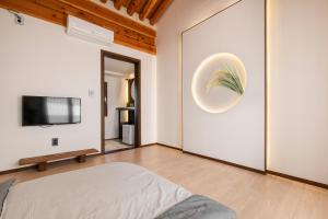 a bedroom with a bed and a flat screen tv at Gyeongju Wonhwaru in Gyeongju