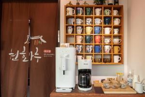 a coffee maker on a counter next to a cupboard at Gyeongju Wonhwaru in Gyeongju