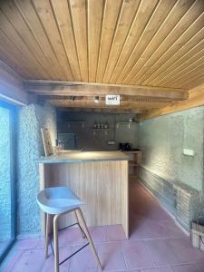 a counter with a blue stool in a kitchen at Vino Vista in Tʼelavi