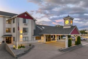 a hotel with a clock tower in front of a building at Best Western Plus Great Northern Inn in Havre