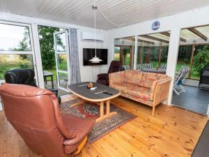 a living room with a couch and a table at 6 person holiday home in Thyholm in Thyholm