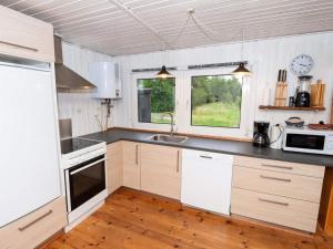 a kitchen with a sink and a counter top at 6 person holiday home in Thyholm in Thyholm