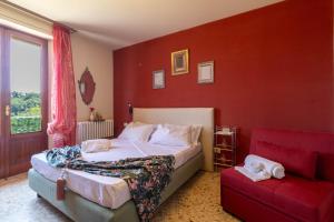 a bedroom with a bed and a red wall at Villa with Sea View Parking in Lapedona +47 photos