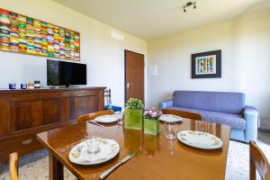a living room with a table and a couch at Villa with Sea View Parking in Lapedona