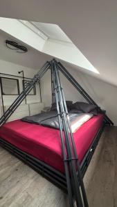a bed in a room with a metal frame at Über den Dächern im Vier Vorne in Gütersloh +4 photos