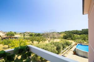 a balcony of a house with a swimming pool at Villa with Sea View Parking in Lapedona