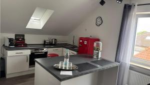 a kitchen with a red refrigerator and a counter at Über den Dächern im Vier Vorne in Gütersloh