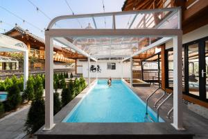 a swimming pool in a house with a glass roof at Gyeongju Jiseom Hanok Pool Villa Pension in Gyeongju +55 photos