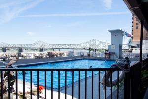 a swimming pool with a bridge in the background at Galt House Hotel, A Trademark Collection Hotel in Louisville