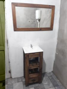 a bathroom with a sink and a mirror at Cabaña Piedra Blanca in San Rafael