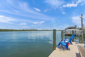 dos sillas azules sentadas en un muelle en el agua en Coastal Breeze Siesta Manatee "C", en Sarasota