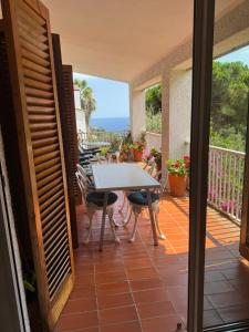 a patio with a table and chairs on a balcony at Apartamentos Escorpion Tossa de Mar in Tossa de Mar