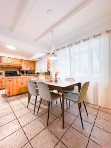 a dining room with a table and chairs in a kitchen at 6BR Pool Escape for Friends and Family - LOU1 - BUR in Burbank