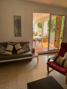 a living room with a couch and a sliding glass door at Villa Escorpion Tossa de Mar in Tossa de Mar